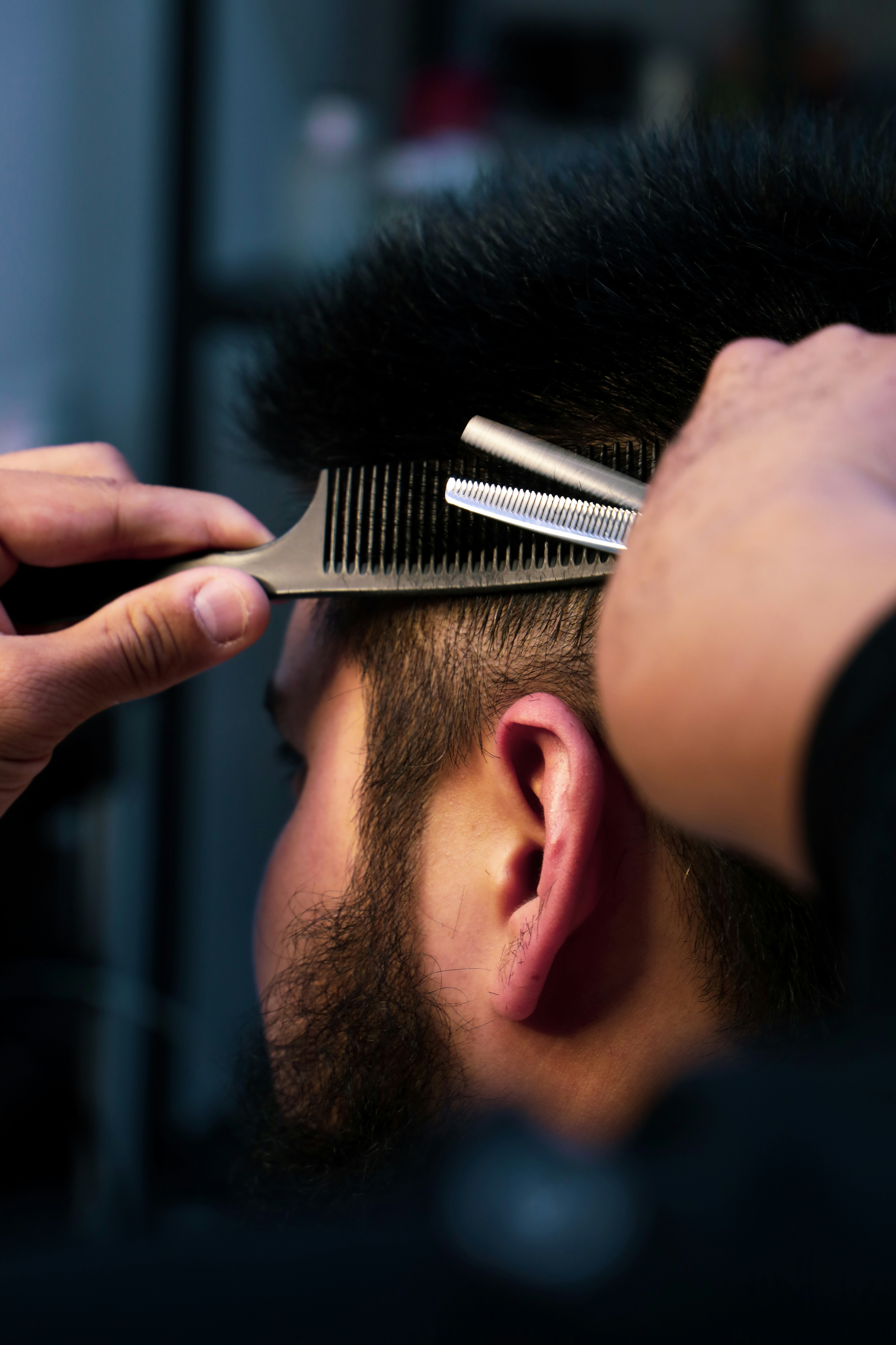 Barber styling client's hair
